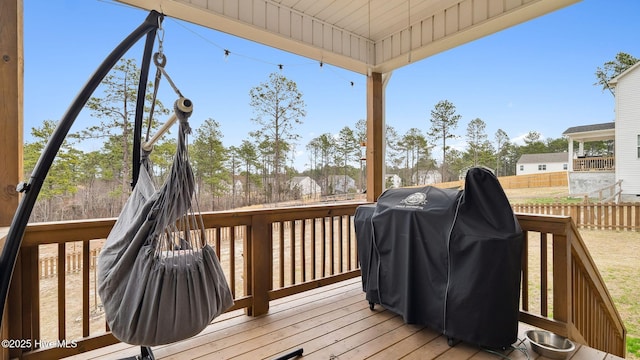 wooden terrace with area for grilling and fence