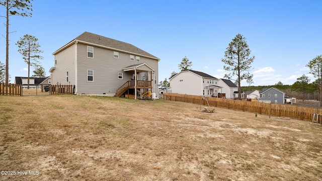 back of property with crawl space, a yard, and fence private yard