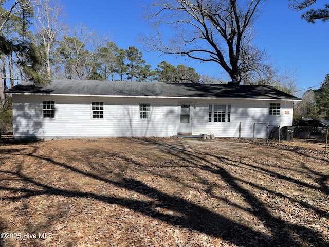 back of house with fence