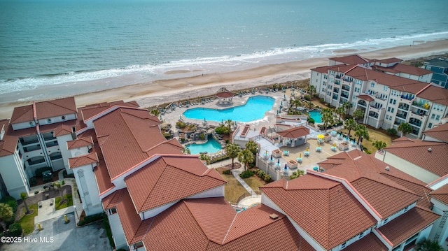 birds eye view of property featuring a water view and a view of the beach