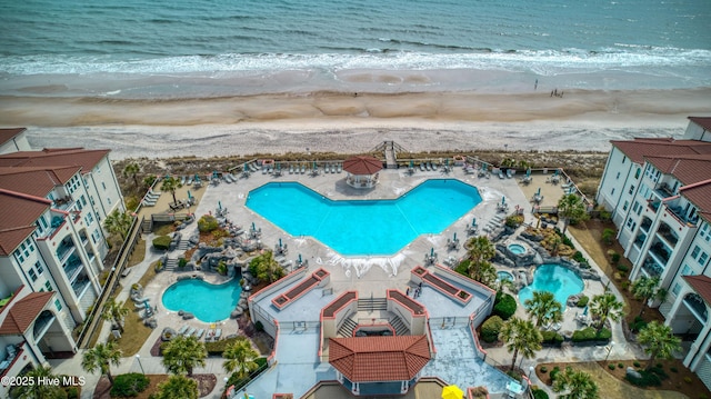 bird's eye view featuring a water view and a beach view