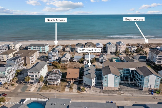 bird's eye view with a residential view, a water view, and a beach view