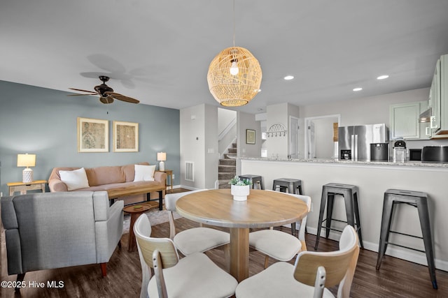 dining room featuring baseboards, ceiling fan, stairway, recessed lighting, and dark wood-style floors