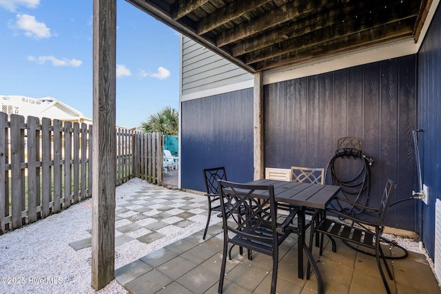 view of patio with outdoor dining space and a fenced backyard