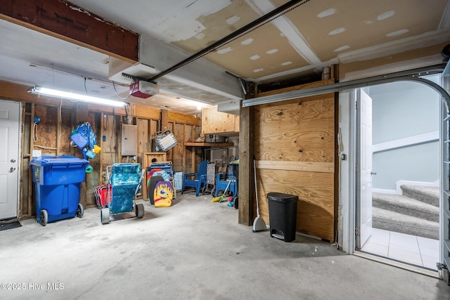 garage featuring electric panel and a garage door opener