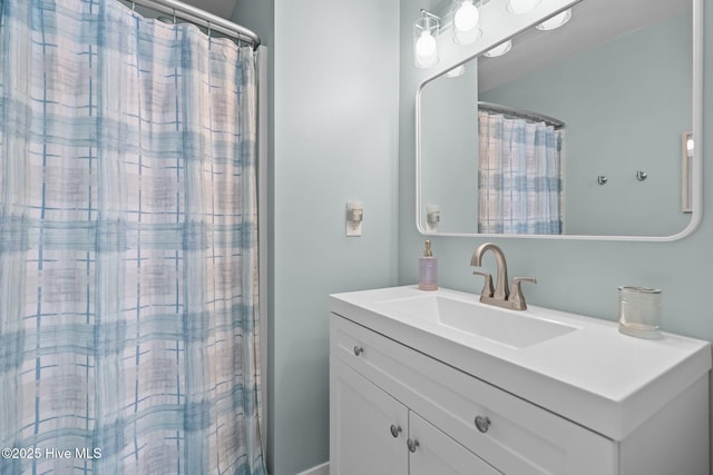 bathroom featuring vanity and curtained shower