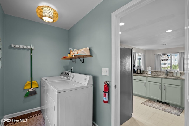 clothes washing area with baseboards, light floors, laundry area, recessed lighting, and washer and dryer