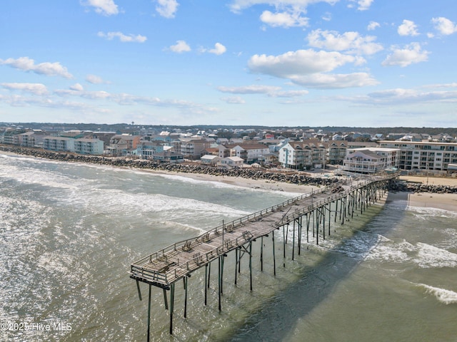 aerial view with a water view and a beach view