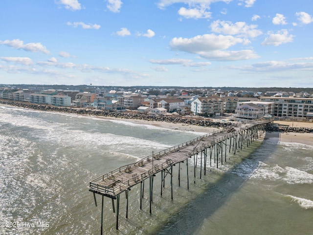 drone / aerial view featuring a beach view and a water view