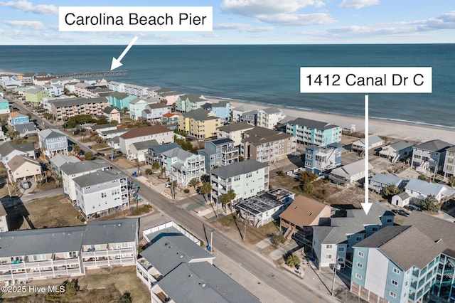 birds eye view of property with a beach view and a water view