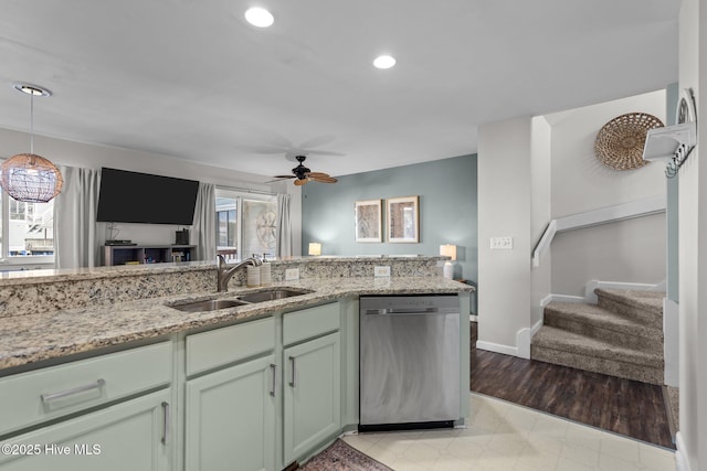 kitchen featuring light stone counters, a sink, a ceiling fan, and stainless steel dishwasher