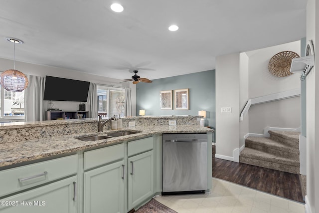 kitchen featuring stainless steel dishwasher, a sink, ceiling fan, light stone countertops, and recessed lighting