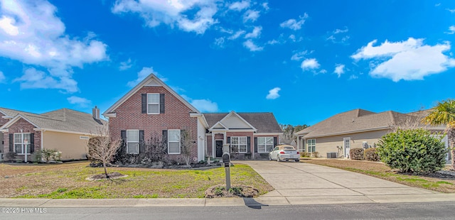 traditional-style home featuring central air condition unit, brick siding, concrete driveway, and a front lawn