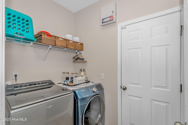 washroom featuring washer and clothes dryer and laundry area