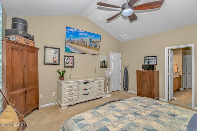 bedroom featuring a ceiling fan, ensuite bath, baseboards, light colored carpet, and vaulted ceiling