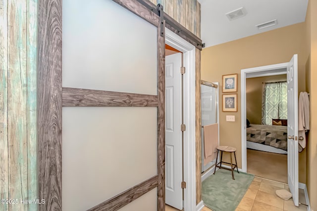 ensuite bathroom with visible vents, a shower stall, ensuite bathroom, and tile patterned flooring