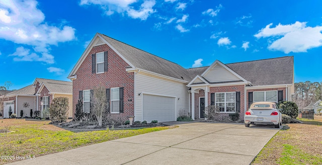 traditional home with brick siding, driveway, and a front yard