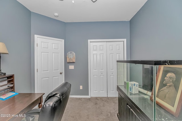 home office with light colored carpet and baseboards