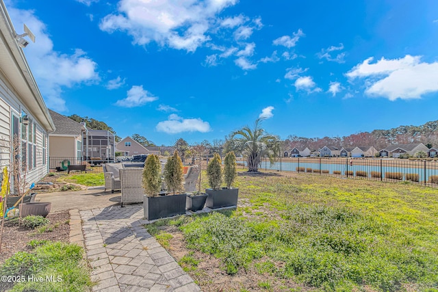 view of yard featuring a residential view, a patio, and fence