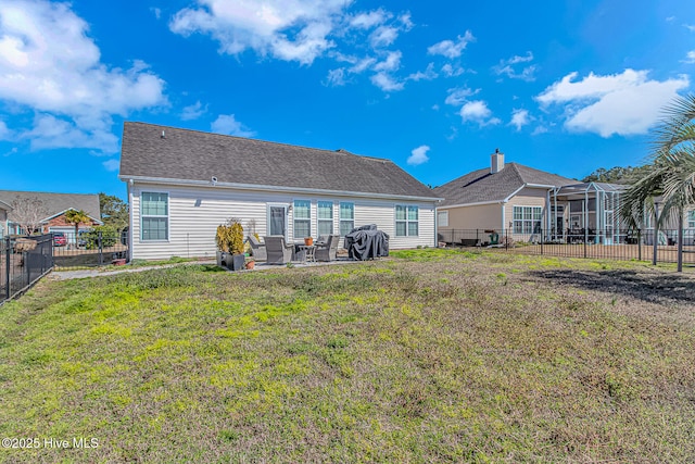 back of house featuring a patio, a lawn, and a fenced backyard