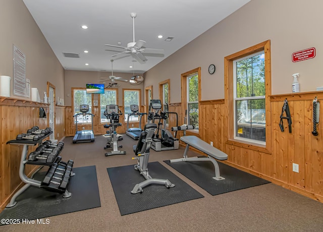 workout area with a wealth of natural light, recessed lighting, and wainscoting