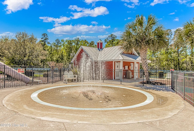 view of home's community featuring fence