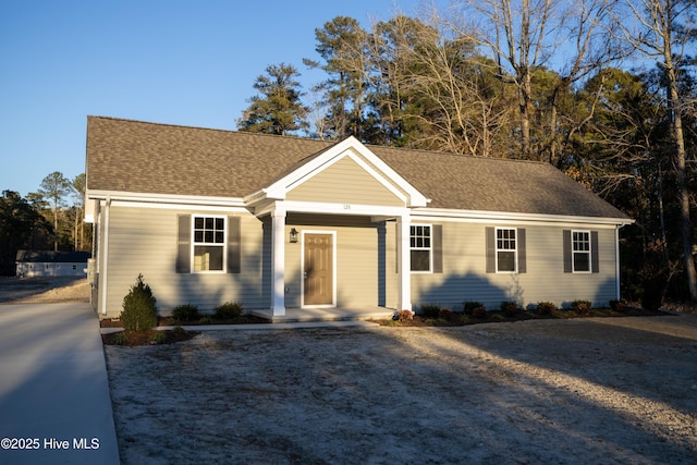 ranch-style house with roof with shingles