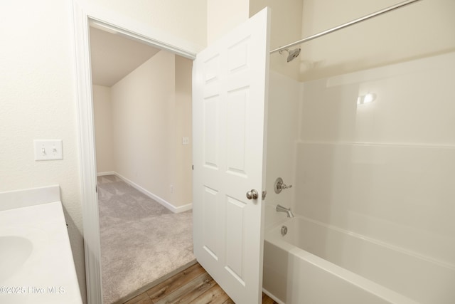 full bathroom with vanity, shower / bathtub combination, and wood finished floors