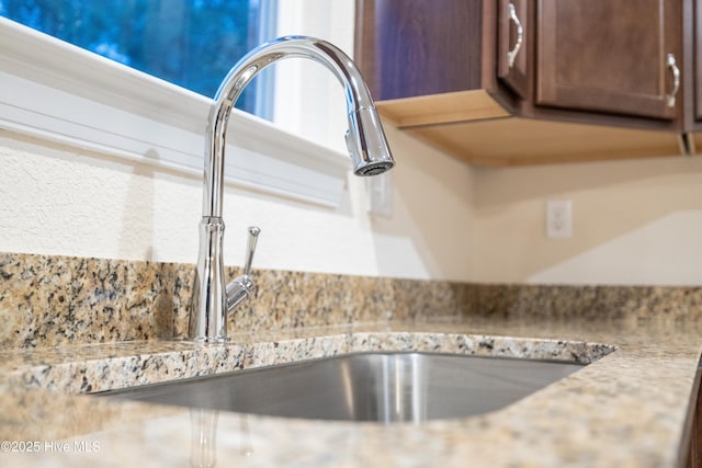 interior details featuring light countertops and a sink