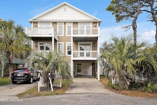 coastal inspired home featuring a carport and driveway