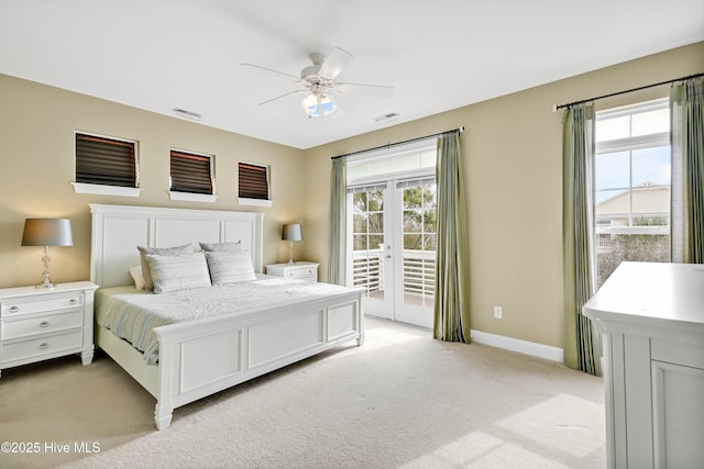 bedroom with light carpet, visible vents, multiple windows, and access to outside