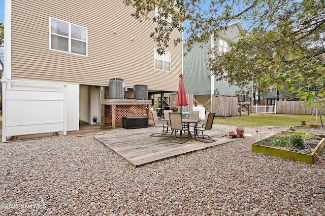 exterior space featuring central AC unit, a vegetable garden, and fence