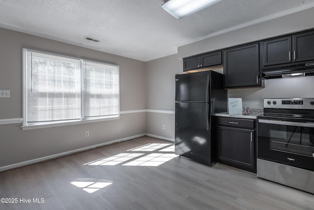 kitchen featuring light wood-type flooring, under cabinet range hood, a textured ceiling, freestanding refrigerator, and stainless steel electric range oven
