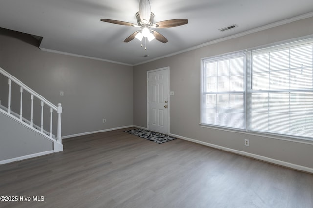 entrance foyer with visible vents, wood finished floors, stairs, and ornamental molding