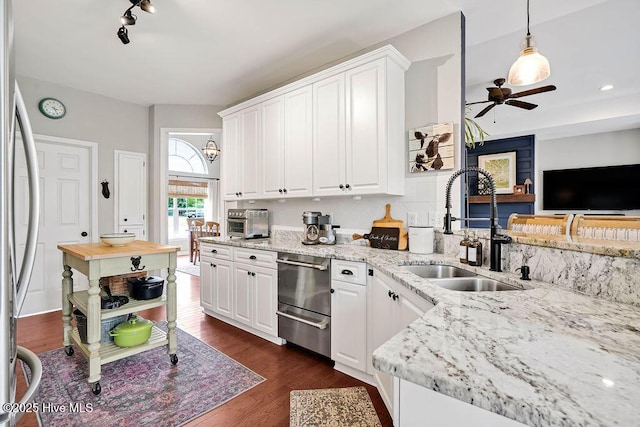 kitchen featuring dark wood-type flooring, ceiling fan, stainless steel refrigerator, white cabinets, and a sink