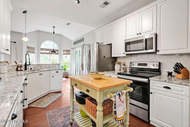 kitchen with a sink, stainless steel appliances, visible vents, and white cabinetry