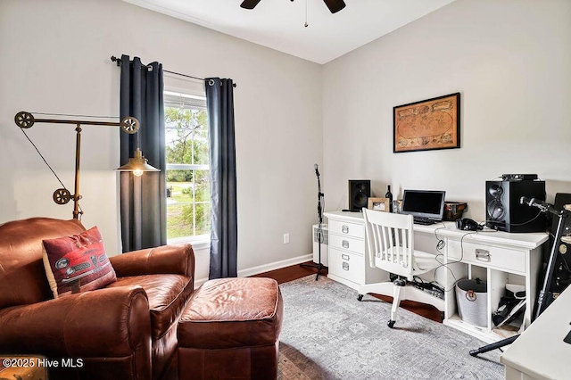 office area featuring baseboards, a ceiling fan, and wood finished floors