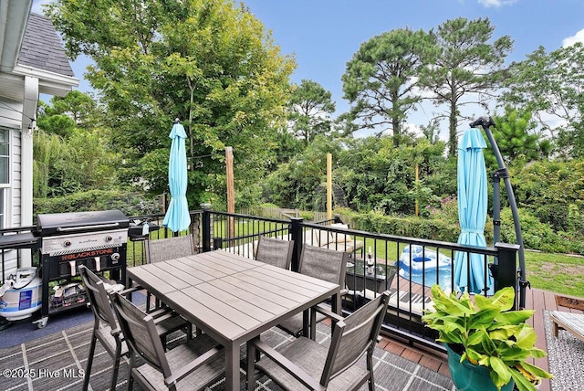 deck featuring outdoor dining area and area for grilling