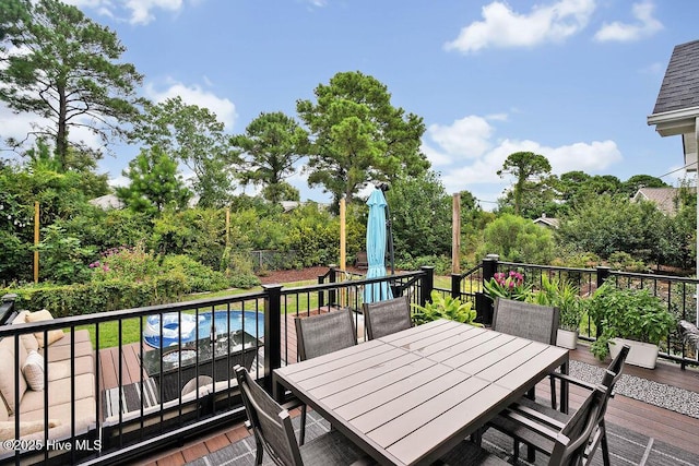 wooden terrace featuring outdoor dining space