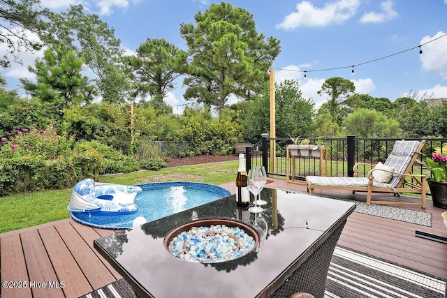 view of pool with a yard and a wooden deck