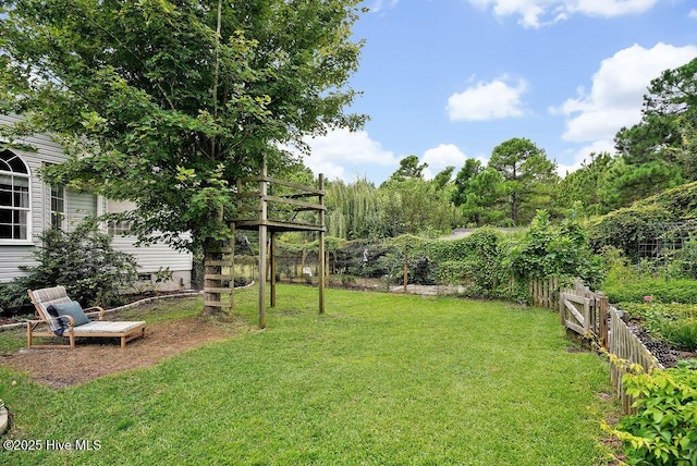 view of yard with stairway, a deck, and fence