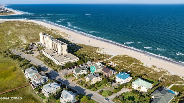 birds eye view of property with a beach view and a water view