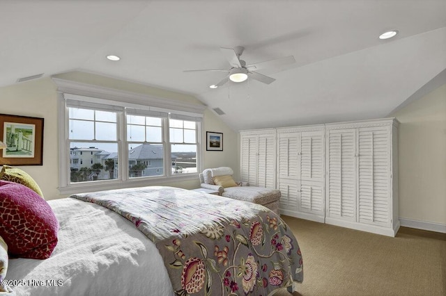 carpeted bedroom featuring vaulted ceiling, recessed lighting, visible vents, and ceiling fan