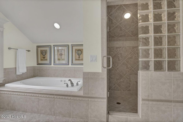 full bath with a shower stall, a garden tub, and vaulted ceiling