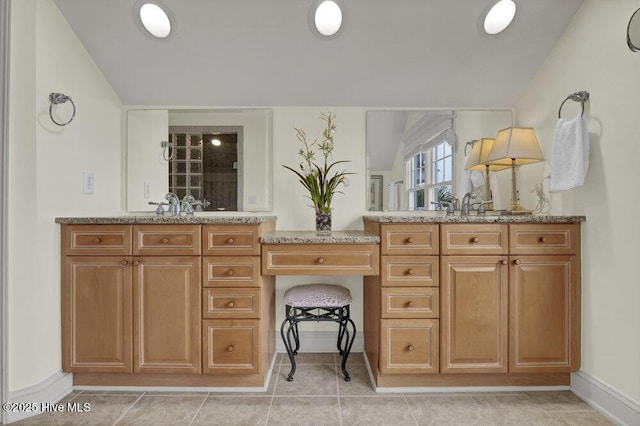 bathroom with tile patterned floors, lofted ceiling, and vanity