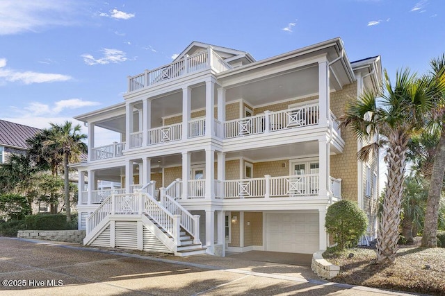 coastal inspired home with stairway and an attached garage