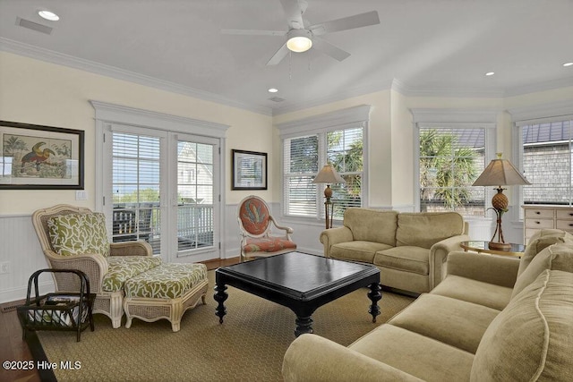 2628 N Lumina Ave, Wrightsville Beach, NC 28480 - living area featuring plenty of natural light, a wainscoted wall, wood finished floors, ceiling fan, and crown molding