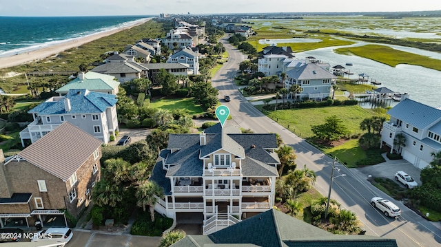 drone / aerial view with a view of the beach, a water view, and a residential view