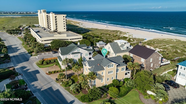 birds eye view of property with a beach view and a water view