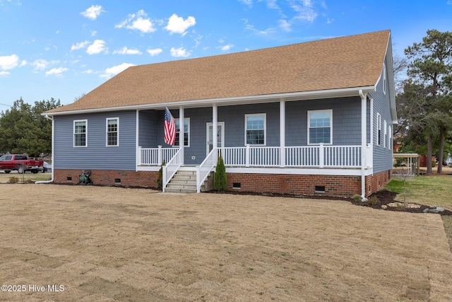 view of front facade featuring a front yard, covered porch, roof with shingles, and crawl space